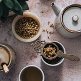Rustic stone photography surface with plant, tea and honey