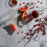 Atlas Food Photography Background with grapefruit slices, pomegranate, seasoned salt and glass of juice