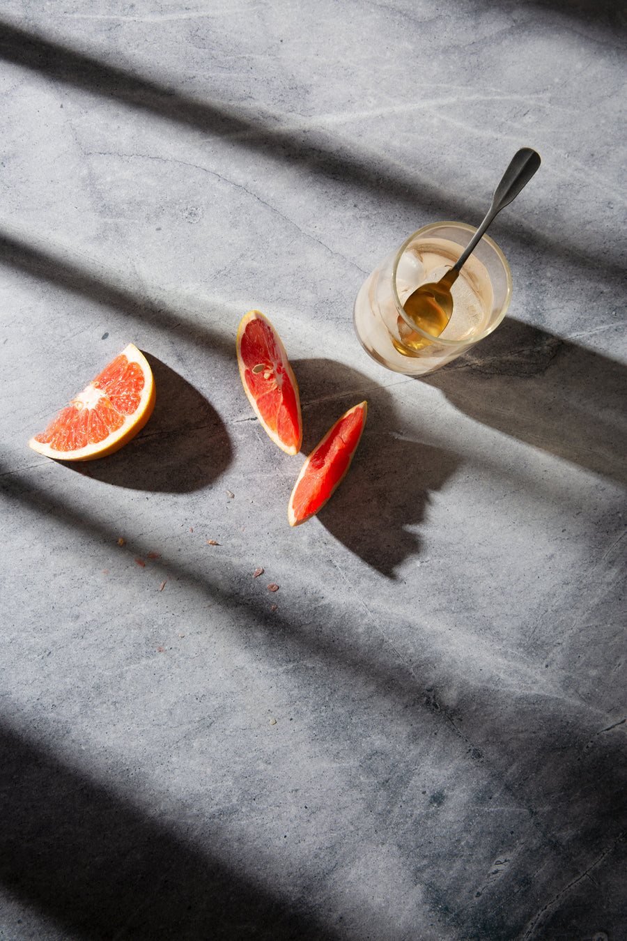 Birch Food Photography Background with slices of grapefruit, a cold drink and dramatic shadows