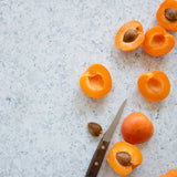 Caspian Food Photography Background with sliced apricots and knife