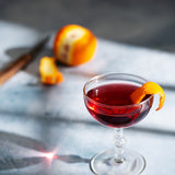 Light blue painted photography surface with red cocktail