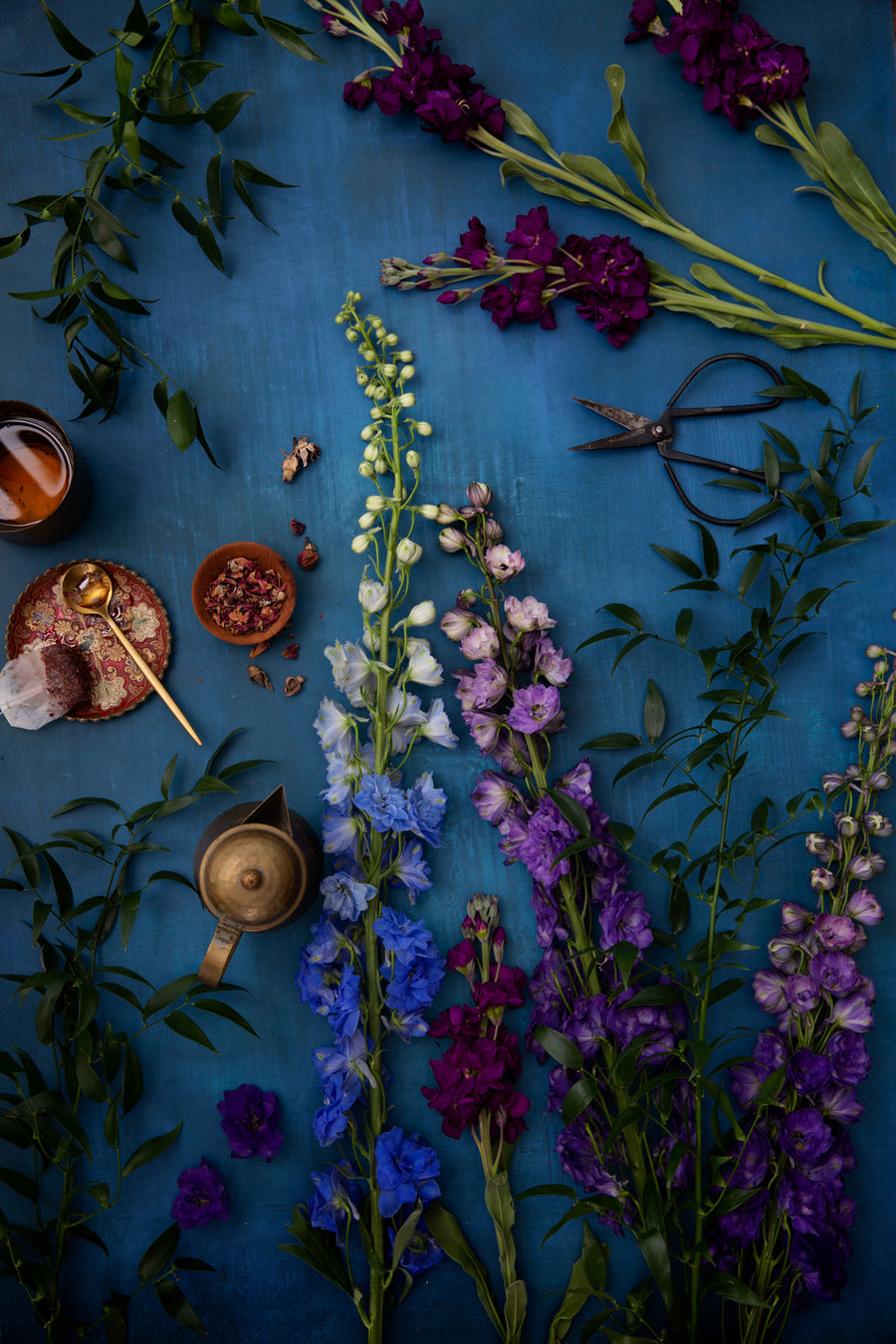 Dark & moody blue photography surface with flowers