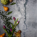 Rustic blue metal photography surface with pears, artichokes and flowers