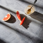 Birch Food Photography Background with slices of grapefruit, a cold drink and dramatic shadows