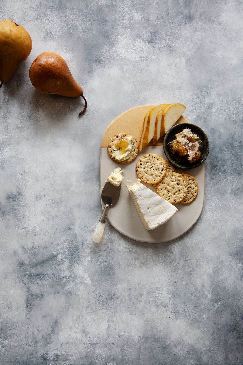 Clay Food Photography Background with cheese, crackers and pears