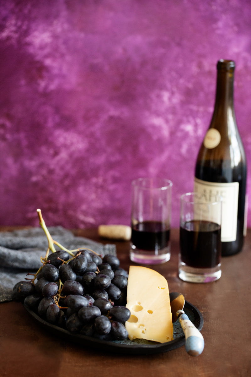 Violet Food Photography Background with cheese, wine and fruit